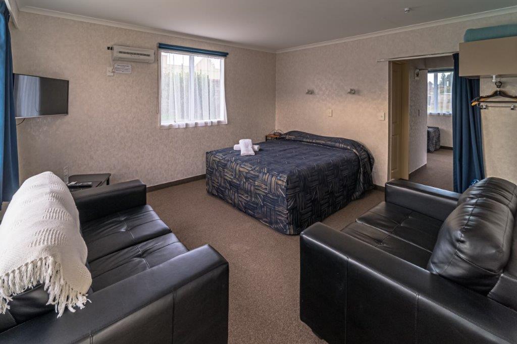 Family Unit showing q ueen bed and seating Parklands Accommodation